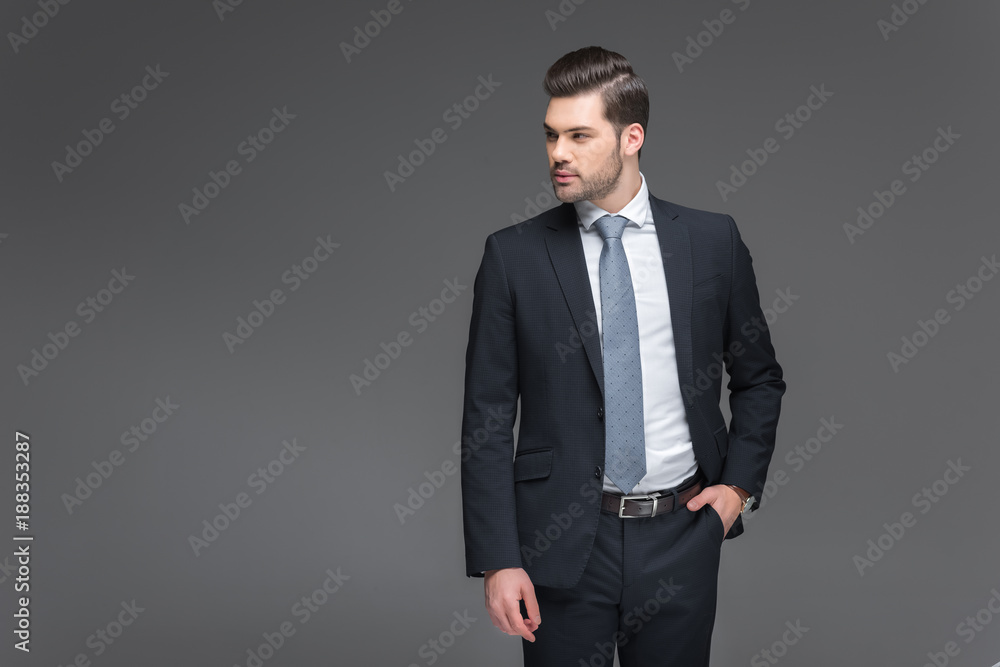 handsome bearded businessman in black suit, isolated on grey handsome bearded businessman in black suit, isolated on grey