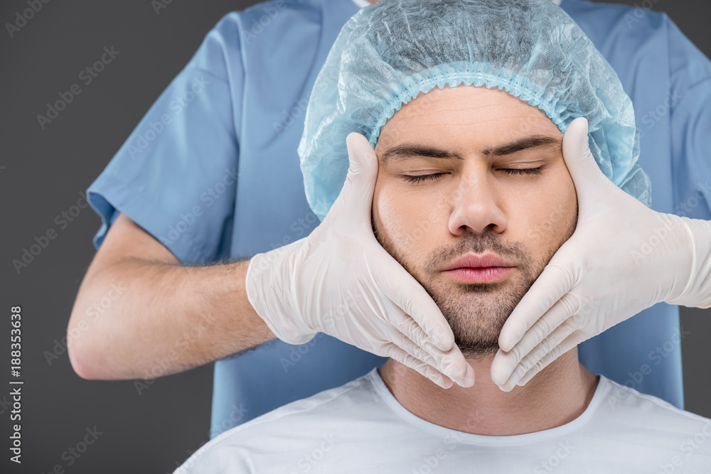 bearded handsome man with closed eyes ready to facelift, isolated on grey bearded handsome man with closed eyes ready to facelift, isolated on grey