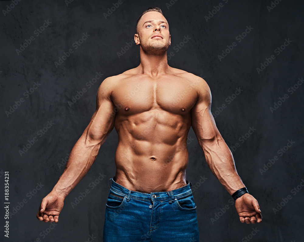 Fototapeta premium Portrait of shirtless muscular male in a jeans.