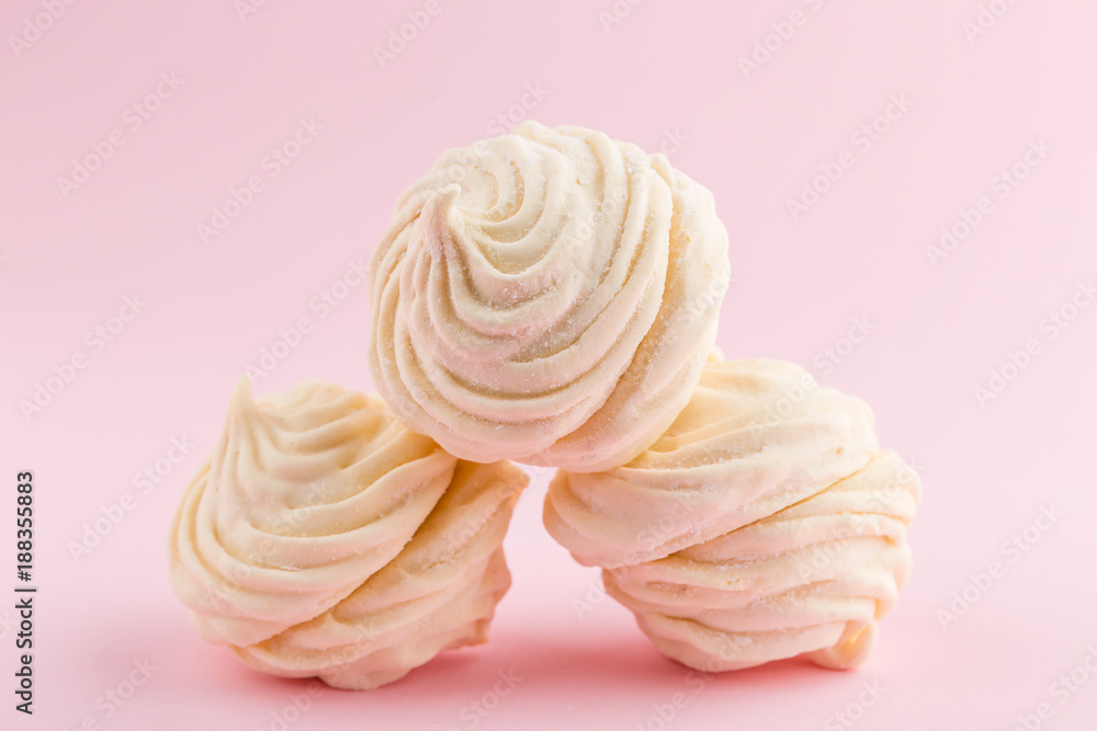 Homemade white zephyr or marshmallow on pink background Homemade white zephyr or marshmallow on pink background