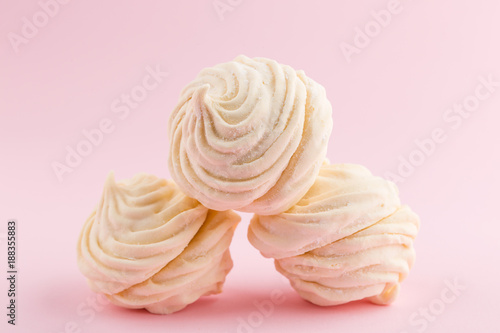 Homemade white zephyr or marshmallow on pink background