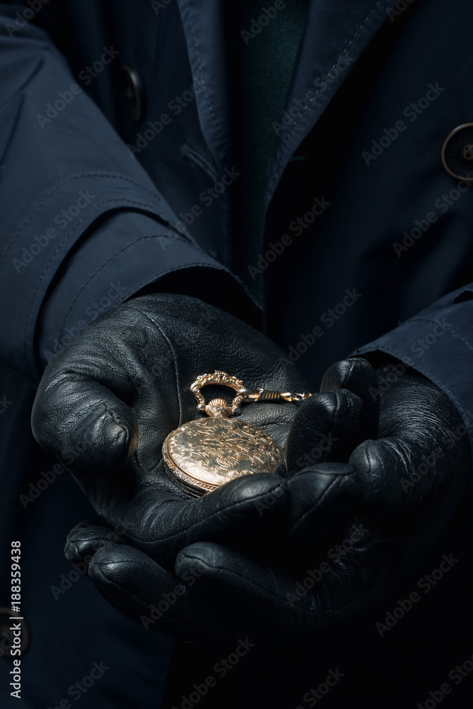 Ancient vintage gold watch in male hands