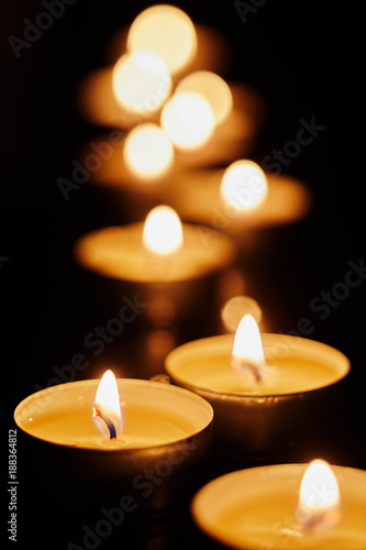 Votive candles burning in the darkness