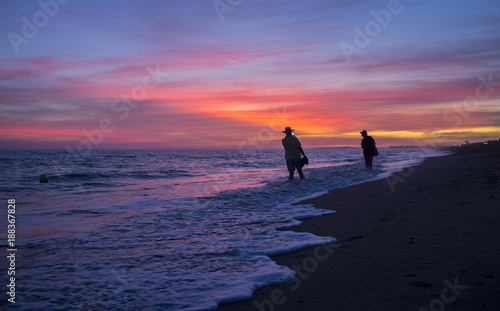 Elder tourist couple taking pictures at Islantilla beach during the magnificent sunrise © WH_Pics