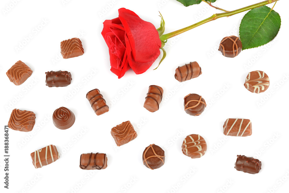 Assortment of chocolates and red rose isolated on white background. Flat lay, top view.