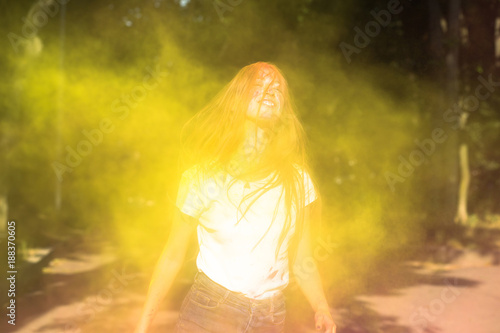 Positive blonde model having fun at Holi paint party