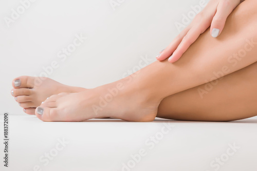 Woman's legs. Cares about clean and soft skin after shaving or depilation. Body care concept.