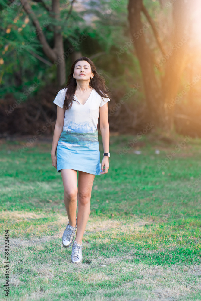 Happy woman jumping with nature at public park. Happy woman jumping with nature at public park.