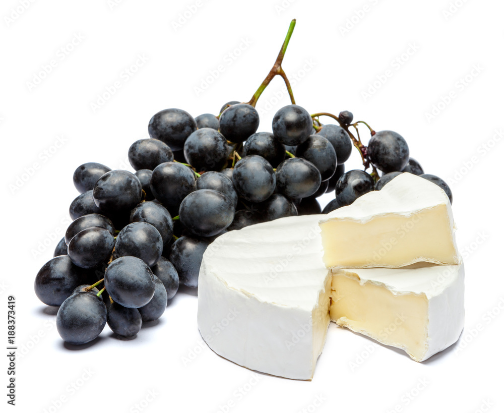 Round brie or camambert cheese and grapes on a white background