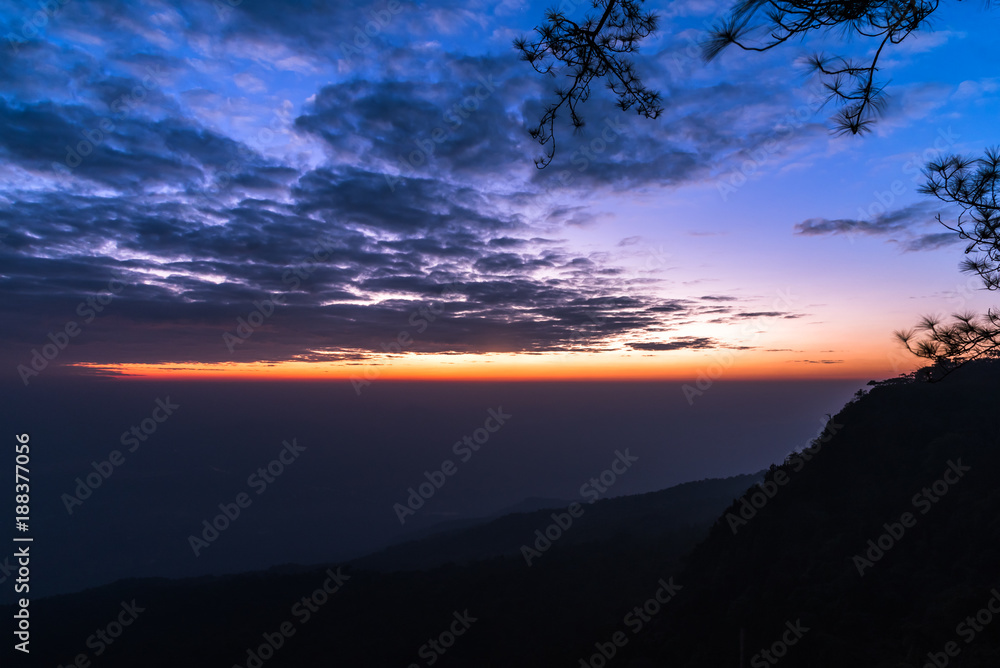 Colorful sky and mountains before sunrise at Phukradueng National Park, Thailand.