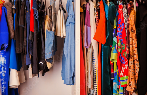 Colorful collection of women's clothes hanging on a rack