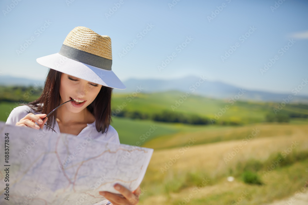 woman holding paper map finding right tourist route