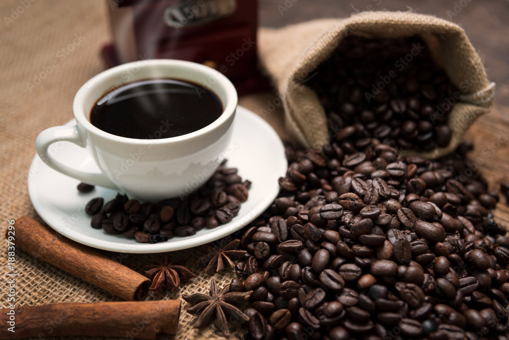 Closeup of coffee beans and bag on wooden table Closeup of coffee beans and bag on wooden table