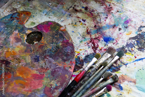 workplace painter palette with colors and brushes. Palette of colors, creative disorder, art