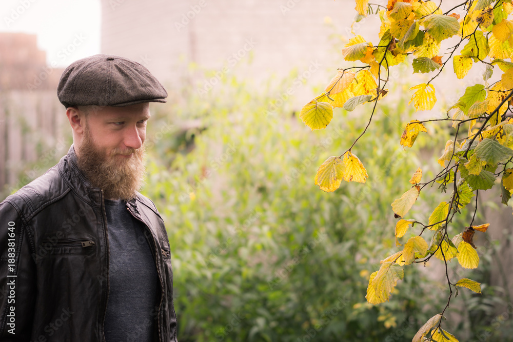 Autumn vintage style - man with beard, flat cap and leather jacket