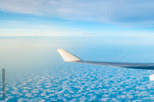 Airplane wing with clouds.