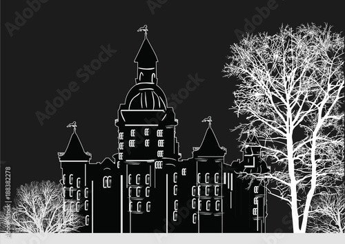 castle outline behind bare trees isolated on black