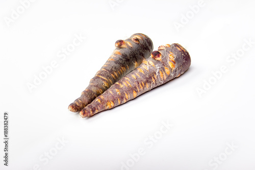 a violet carrot mirrored on white background
