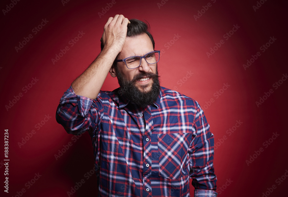 Confused man scratching head st studio shot . Confused man scratching head st studio shot .