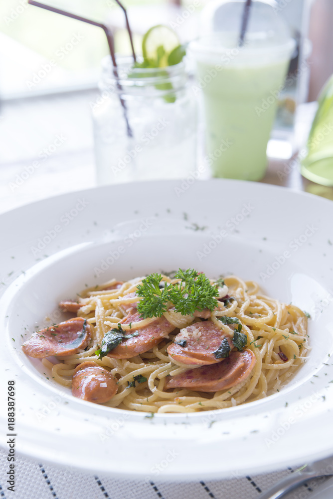 Spicy spaghetti and homemade sausage with thai style cooking, fusion food between italian food and thai ingredient and cooking style.