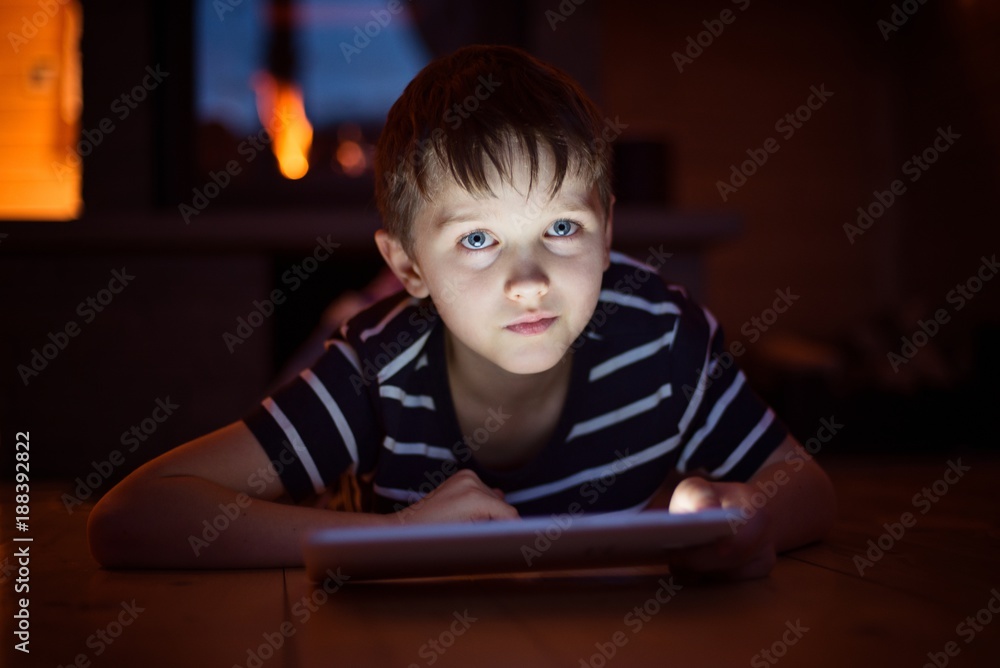 Eight years old boy using digital tablet Eight years old boy using digital tablet
