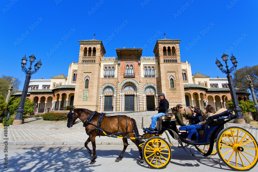 Obraz premium The mudejar pavilion and pond placed in the Plaza de America, houses the Museum of Arts and Traditions of Sevilla, Andalusia,
