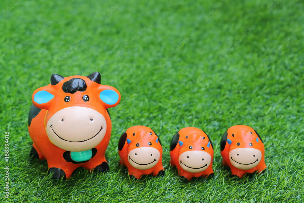 cute toy cow on grass, using as background cute toy cow on grass, using as background