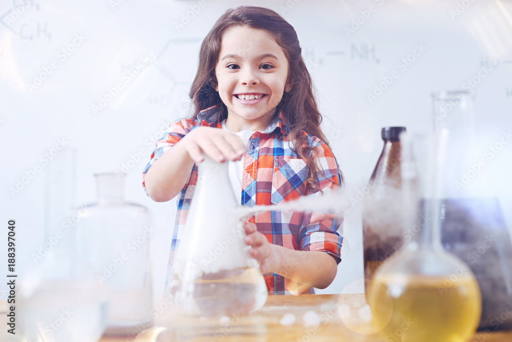 So excited to learn new things. Elementary female student grinning broadly while working with a chemistry set and conducting an experiment during a chemistry lesson. So excited to learn new things. Elementary female student grinning broadly while working with a chemistry set and conducting an experiment during a chemistry lesson.