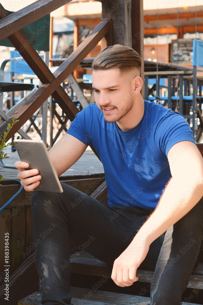Young latin man using a tablet Young latin man using a tablet
