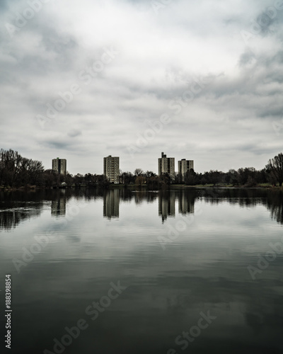 The Lerchenauer Lake in Munich on a cloudy day in fall and with silky smooth water surface