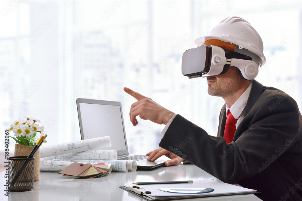 Architect visualizing 3d content in virtual reality glasses in office Architect visualizing 3d content in virtual reality glasses in office