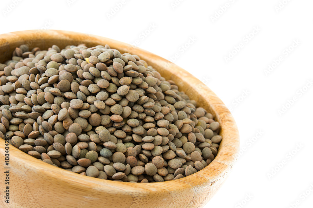 Lentils grain on wooden bowl isolated on white background Lentils grain on wooden bowl isolated on white background