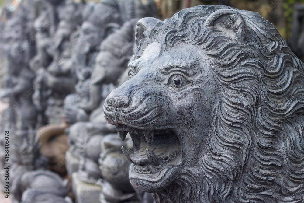 Stone sculpture of lion in the traditional art market of Ubud, Bali