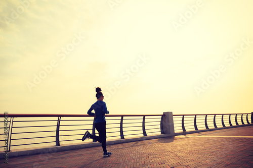 Healthy lifestyle concept, female runner running at seaside