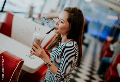 Woman drinks  milkshake at ...
