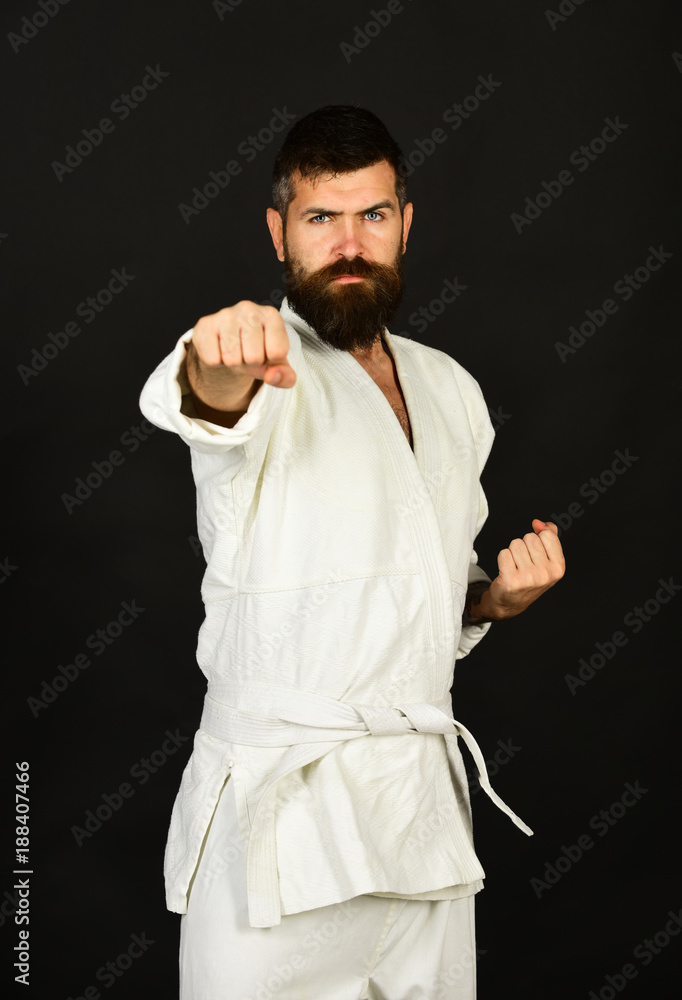 Karate man with confident face in uniform