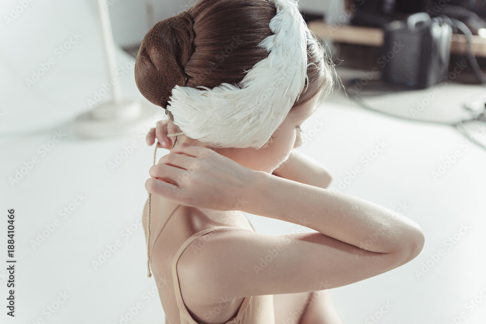 Fototapeta premium Beautiful little ballerina wearing a white swan bandage on her head