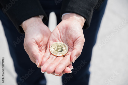 Close up, bitcoins are holding by business man's hands