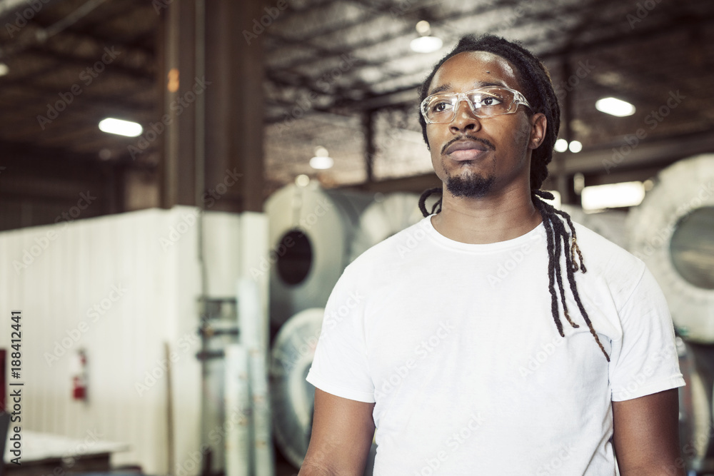 Manual worker wearing protective eyeglasses while working in steel industry Manual worker wearing protective eyeglasses while working in steel industry