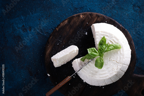 A fresh ricotta with basil leaf on wooden table italian food concept