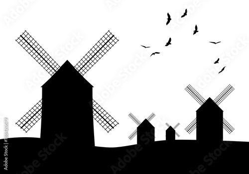Silhouettes of typical Spanish windmills and birds on white background