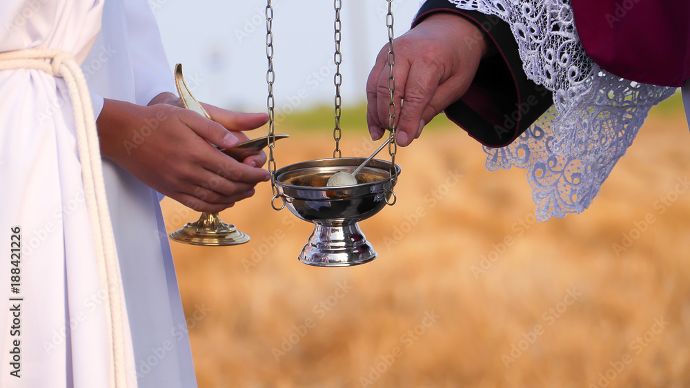 Naklejka premium ordination of the chapel by Catholic priest censer rite smoke