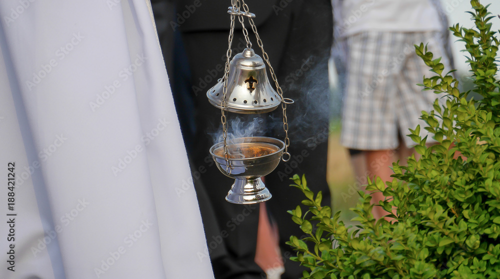 Naklejka premium ordination of the chapel by Catholic priest censer rite smoke