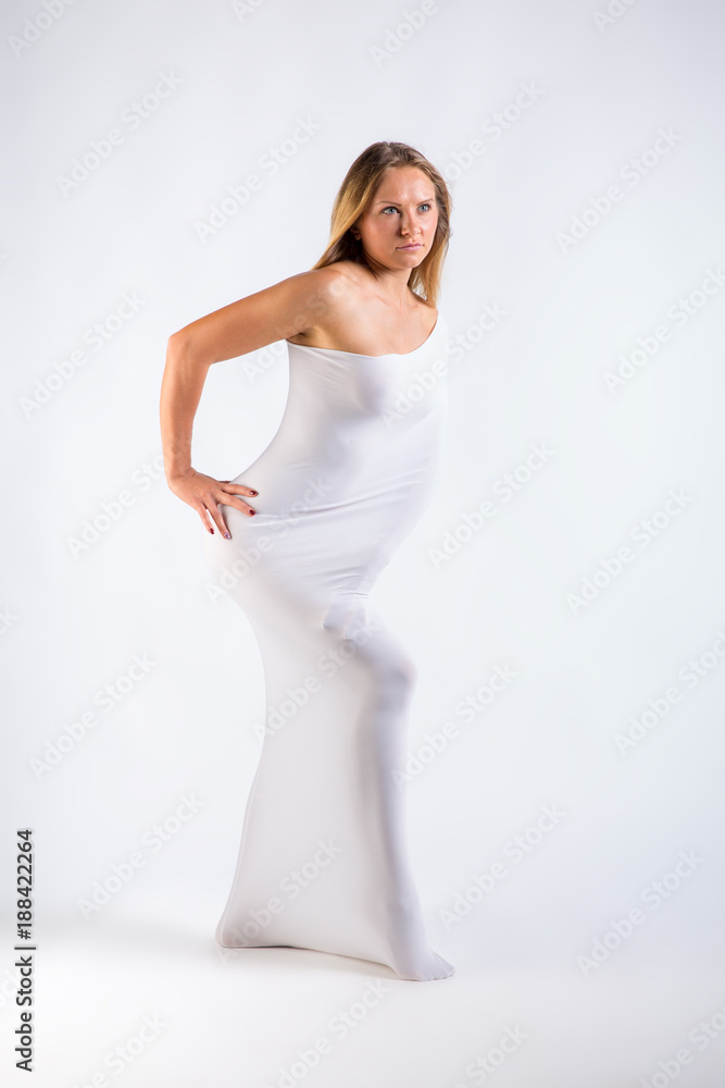 slim nude woman through cloth in white studio slim nude woman through cloth in white studio