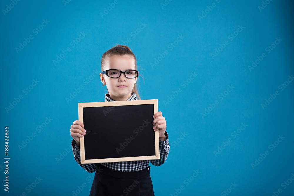 isolated on blue, attractive caucasian child hold big empty poster isolated on blue, attractive caucasian child hold big empty poster