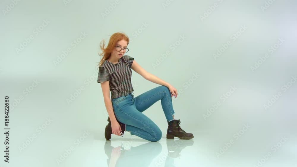 Beautiful red-haired girl with glasses on a white background Beautiful red-haired girl with glasses on a white background