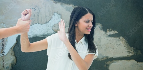 Fotografi Composite image of fearful brunette being grabbed by the hand