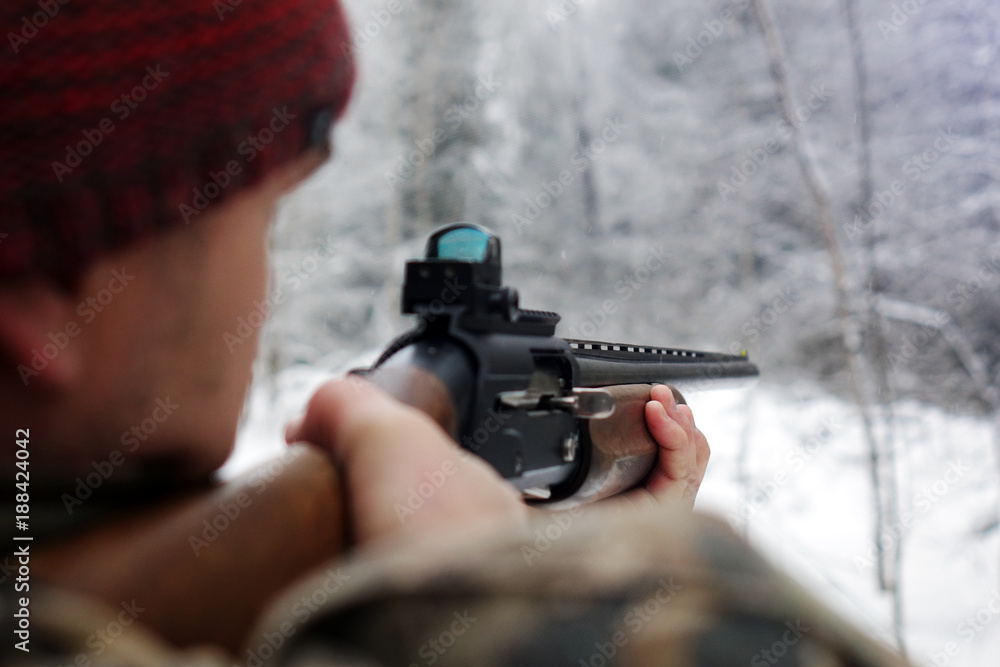 Obraz premium A hunter with a gun. Winter hunting. Huntsman.