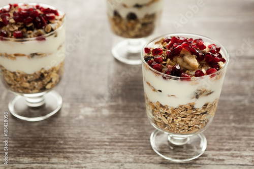 Three glasses with home made muesli on wooden background