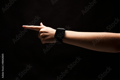 Hand gestures - woman pointing, isolated at black